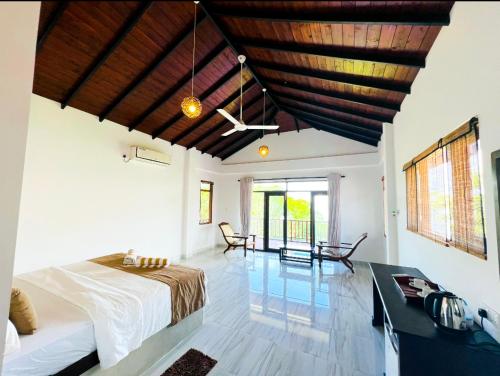 a bedroom with a bed and a desk in a room at Ashansa Lagoon Resort in Tangalle