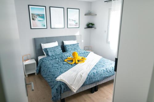 a bedroom with a bed with a yellow toy on it at La Source Positive in Aix-les-Bains