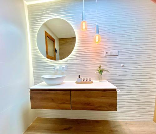 a bathroom with a sink and a mirror at Renteando Albir Apartments in Albir