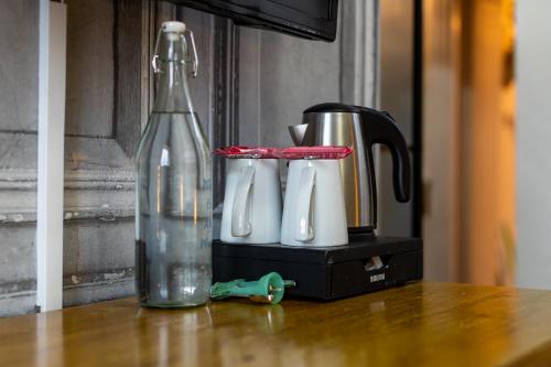a blender and a bottle on a table at Holly Lodge Guest House with FREE off site health club in Windermere