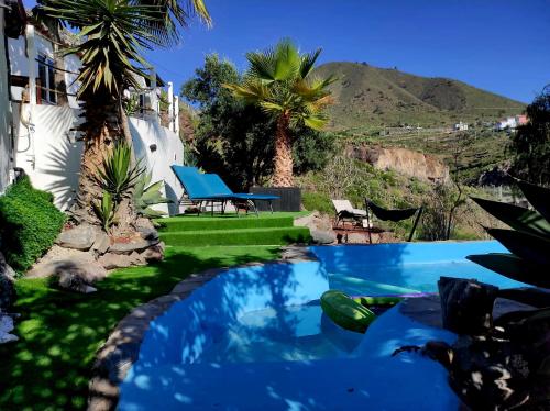 a swimming pool in the yard of a house at Etoile arc-en-ciel in Tejina de Isora