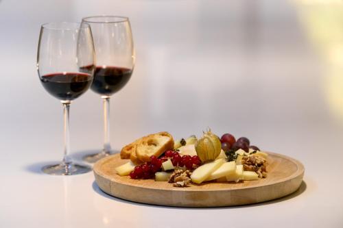 a plate of food and two glasses of wine at Inspira Liberdade Boutique Hotel in Lisbon