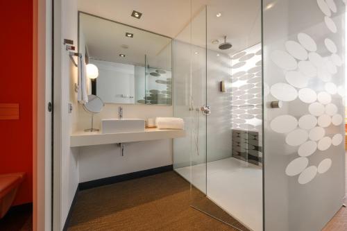 a bathroom with a sink and a shower at Inspira Liberdade Boutique Hotel in Lisbon