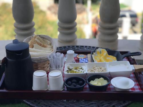 a tray with various food items on a table at Golden White Hotel in Taif