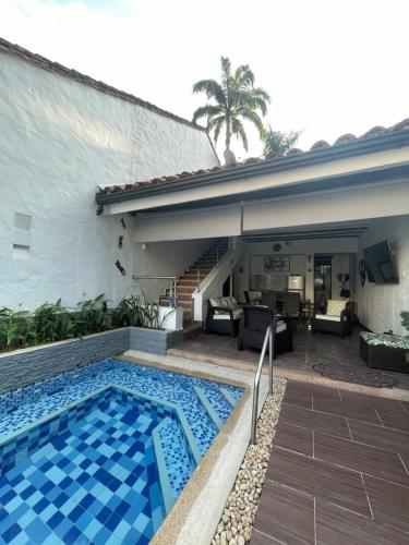 a swimming pool in front of a house at Casa de Descanso in Melgar