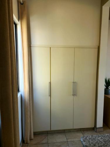 a large white cabinet in the corner of a room at Hotel Paraiso Las Palmas in Ensenada