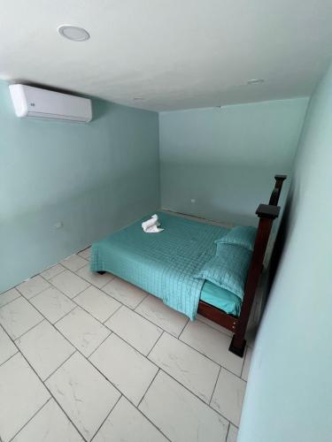 a bedroom with a bed in a room with a tile floor at Casa Tabacon cr in Río Claro