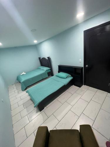 a room with two beds and a couch in it at Casa Tabacon cr in Río Claro