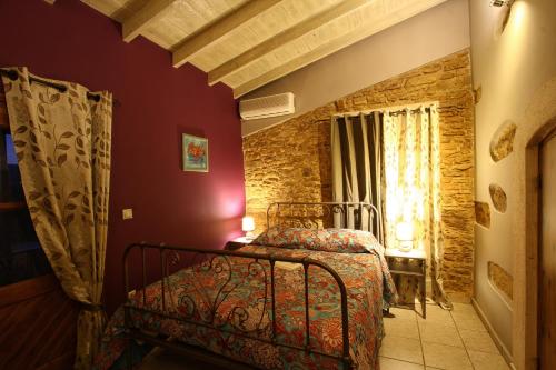 a bedroom with a bed and a window at Venetis Luxury Apartments in Chios
