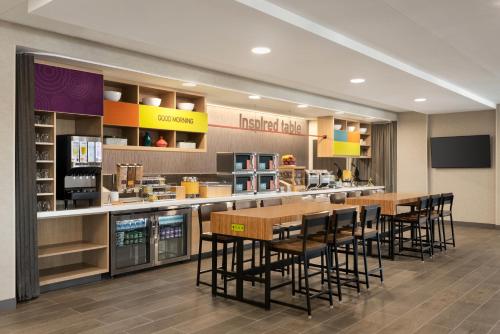 a restaurant with tables and chairs in a cafeteria at Home2 Suites By Hilton Quebec City in Quebec City