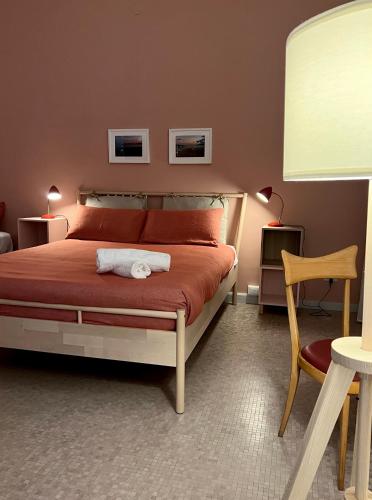 a bedroom with a bed with a white towel on it at Garibaldi R&B in Messina