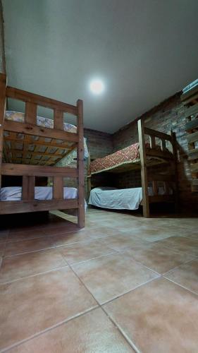 a room with two bunk beds and a tile floor at Elst House in Mendoza