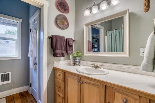 a bathroom with a sink and a mirror at Sunset Beach Manor in Depoe Bay