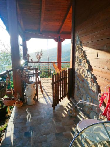a porch of a house with a view of the mountains at Room in Casa Castiglia a Woodhouse with Beautiful View close Madonie Park in Castelbuono