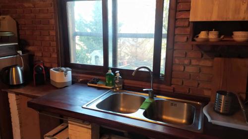 a kitchen counter with a sink and a window at Room in Casa Castiglia a Woodhouse with Beautiful View close Madonie Park in Castelbuono