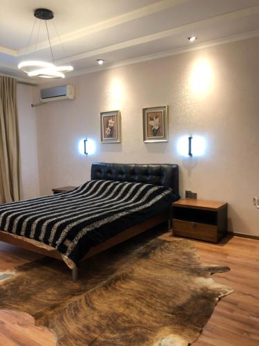 a bedroom with a bed in a room with a rug at Stylish apartments in the heart of the city! in Tashkent