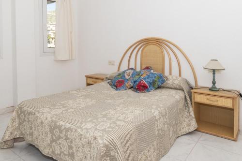 Villas Cap Blanc Ii, Pta 11 في كولرا: غرفة نوم بسرير ومصباح على موقف ليلي