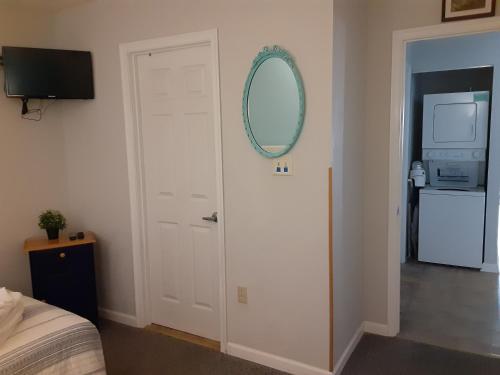 a bedroom with a white door with a mirror on it at Marylander Condominiums, 90 steps from the beach in Ocean City