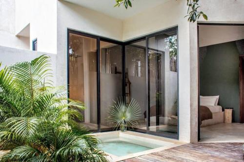 a house with a pool in the middle of a courtyard at Villa 16Tulum in Tulum
