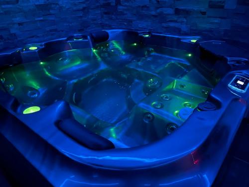 a blue hot tub in a dark room at Residence Pasteur Angouleme in Angoulême
