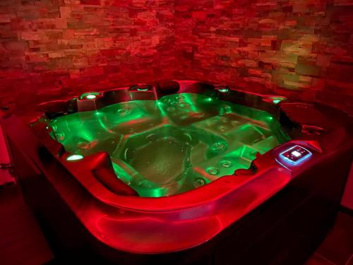 a red and green bath tub in a room at Residence Pasteur Angouleme in Angoulême