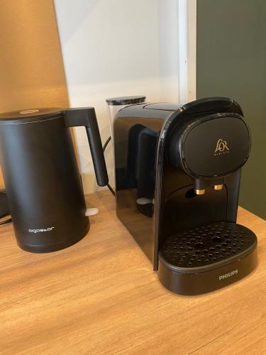 a coffee maker sitting on top of a table at Residence Pasteur Angouleme in Angoulême