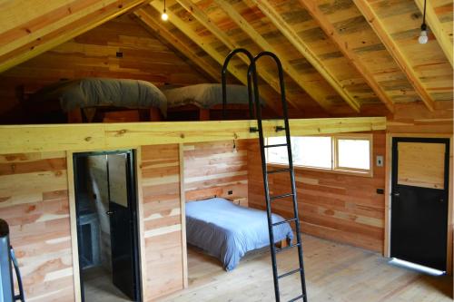 a room with two bunk beds in a cabin at Mágica Cabaña en Parque La Pirámide in La Florida