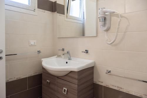 a bathroom with a sink and a mirror at agriturismo masseria pallanzano in Otranto