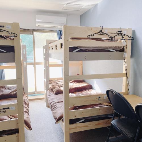 a dorm room with bunk beds and a desk at Cate no mori - Vacation STAY 16675v in Shime