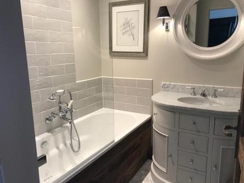 a bathroom with a tub and a sink and a mirror at 3 pièces au pied des pistes avec balcon et WIFI à Tignes - FR-1-449-50 in Tignes