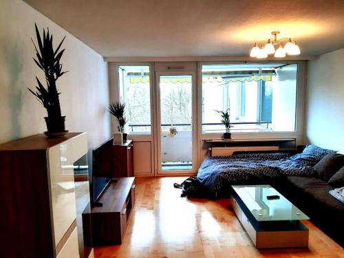 ein Wohnzimmer mit einem Sofa und einem Tisch in der Unterkunft Zentral und doch Natur in Köln