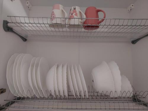 a shelf with plates and cups on it at Яровиця 11 in Luts'k