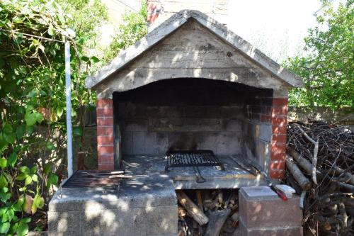 a brick oven with a fire inside of it at Jasmine in Brodarica