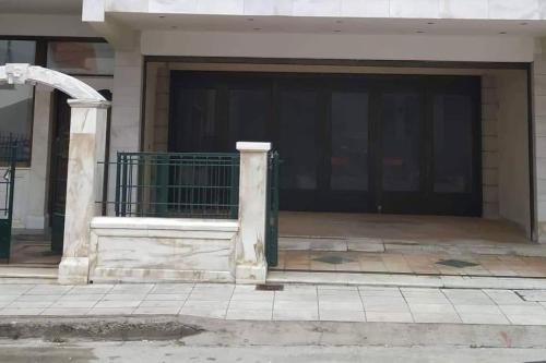 a garage with a gate in front of a building at Best view of Meteora in ''Stavros home'' in Kalabaka