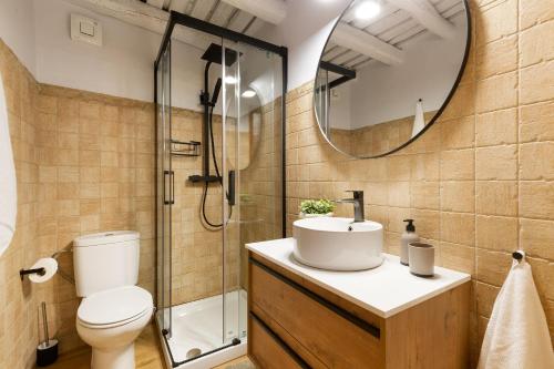a bathroom with a toilet and a sink and a mirror at El Pajar de Jafre , Costa Brava Empordà 