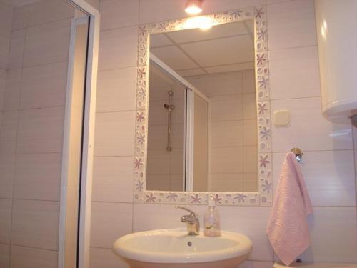 a bathroom with a sink and a mirror at Apartments Nela in Ohrid