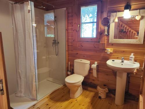 a bathroom with a toilet and a shower and a sink at El Pi Solitari in Camprodon