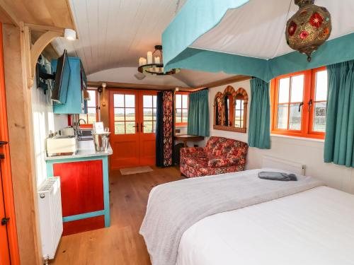 a bedroom with a bed and a couch in a room at The Storyteller in York