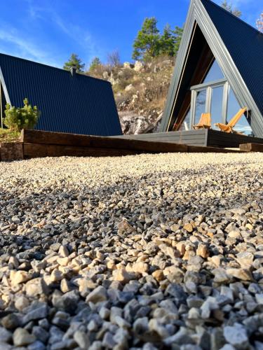 a gravel driveway with a house in the background at Loon Moon Mountain Chalets in Sarajevo