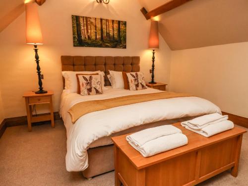 a bedroom with a large bed with two towels on it at Hornington Lodge in York