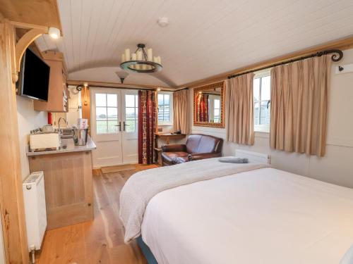 a bedroom with a bed and a chair in a room at The White Princess in York