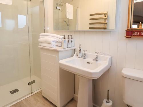 a white bathroom with a sink and a shower at The White Princess in York
