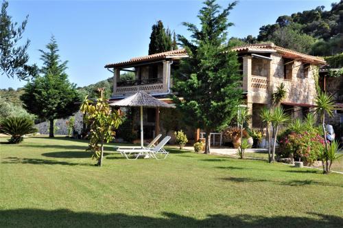 a large house with a balcony and a lawn at Villa Belvedere - 4 bedrooms Sea view House in Vasilikos