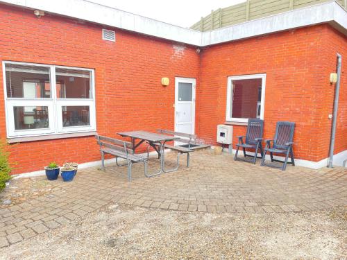 a patio with a table and chairs in front of a brick building at Skjernaa-ferie/ Andersen Invest in Skjern