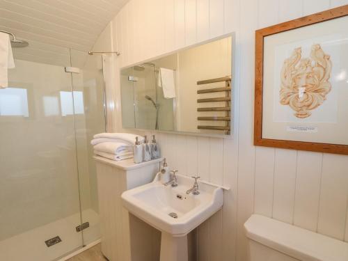 a bathroom with a sink and a shower and a mirror at Folklore in York