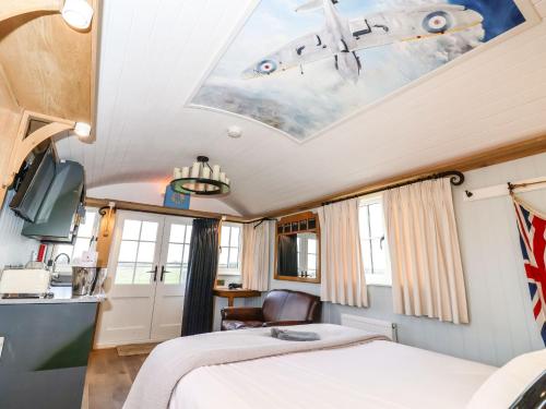 a bedroom in a train with a ceiling with an airplane on it at The Fenton in York