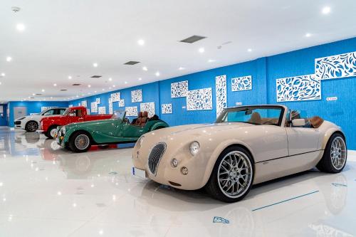 two vintage cars parked in a garage at Lani's Suites de Luxe - Adults Only in Puerto del Carmen