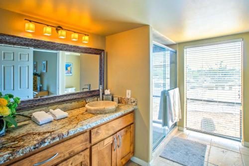 a bathroom with a sink and a large mirror at Carefree Casita with Outdoor Pool and Mountain View! in Carefree