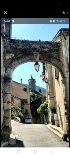 an archway over a street in a city at Charmant studio in Tarascon-sur-Ariège
