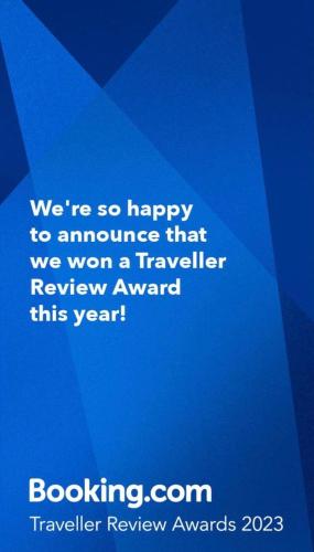 a blue sign that says were so happy to announce that we won a traveler at PK 35 in Apomaoro